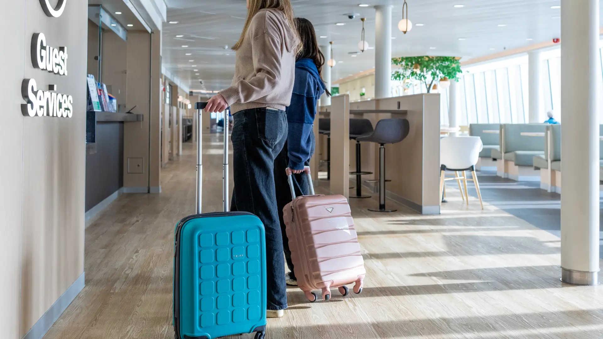 Two people with travel bags on a ferry