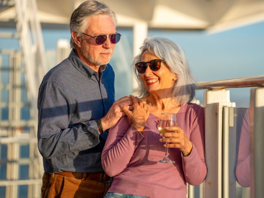 Elderly couple drinking wine onboard ferry