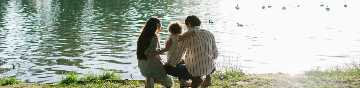 Family by lake in Lake District, England