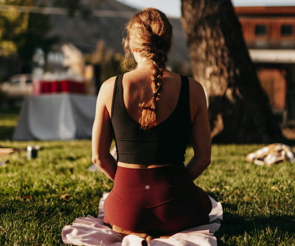 Woman doing yoga at wellness retreat in Europe