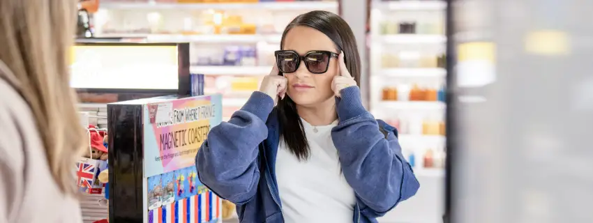 Trying on sunglasses in shop