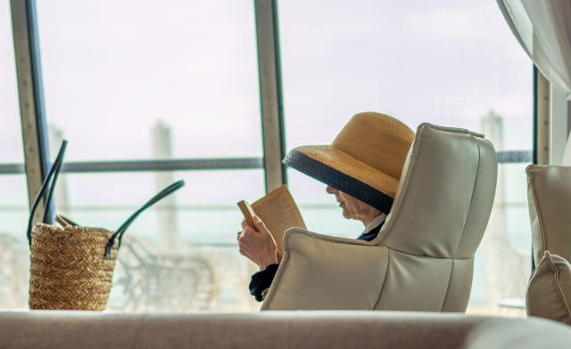Lady relaxing in Club Lounge