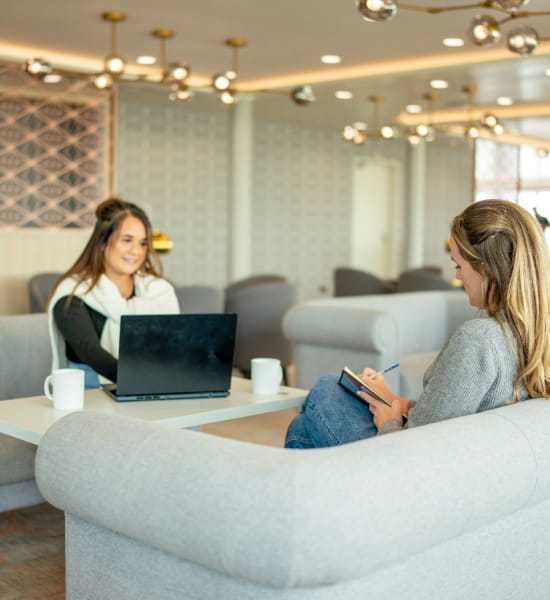 Friends working on laptop in P&O Ferries Club Lounge