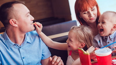 Family Lounge - young family eating and having fun in a booth