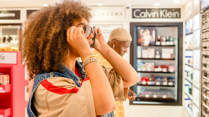 Lady trying on sunglasses in World Duty Free shop on P&O Ferry