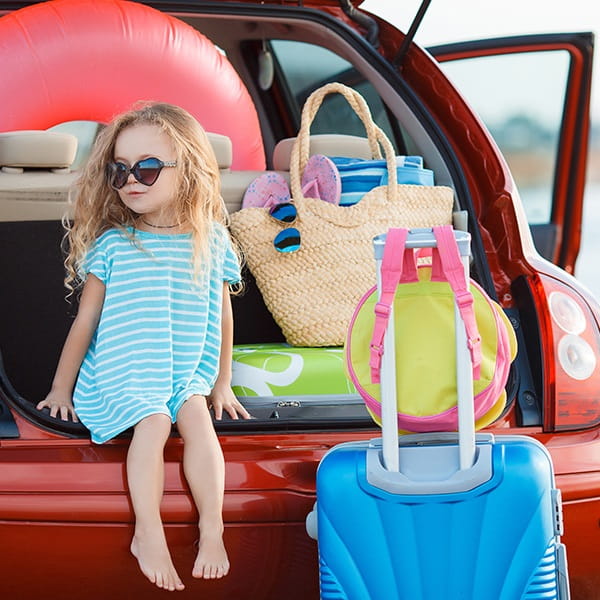 Girl with luggage in car