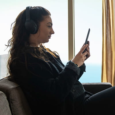 Woman On Tablet In Club Lounge
