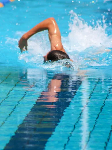 Person swimming in a professional swimming pool