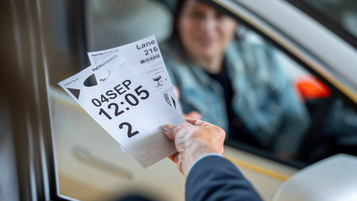 Lady checking in at the check in booth for ferry sailing
