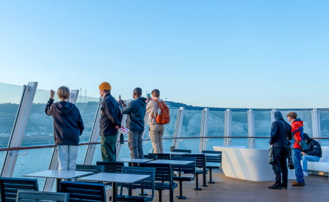 Customers looking at the view of cliffs from Dover ferry