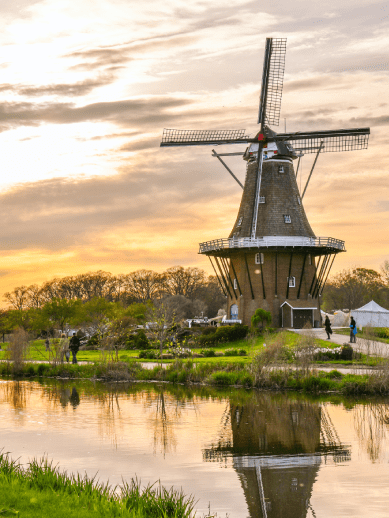 windmill near body of water during daytime